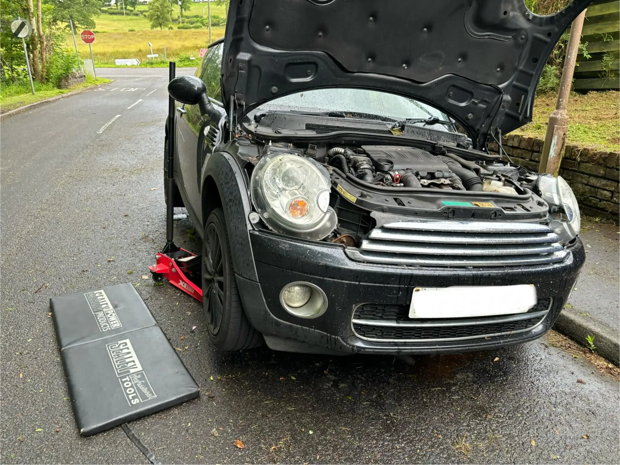 Mobile mechanic working on a car engine in East Dunbartonshire
